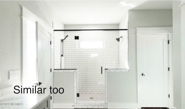 full bath featuring a shower stall and vanity