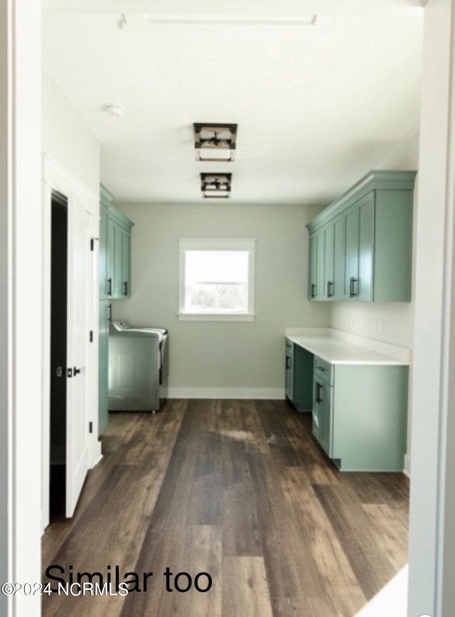 laundry room featuring dark wood-style flooring, cabinet space, and baseboards