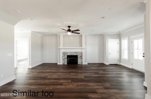 unfurnished living room featuring a fireplace, crown molding, ceiling fan, wood finished floors, and baseboards