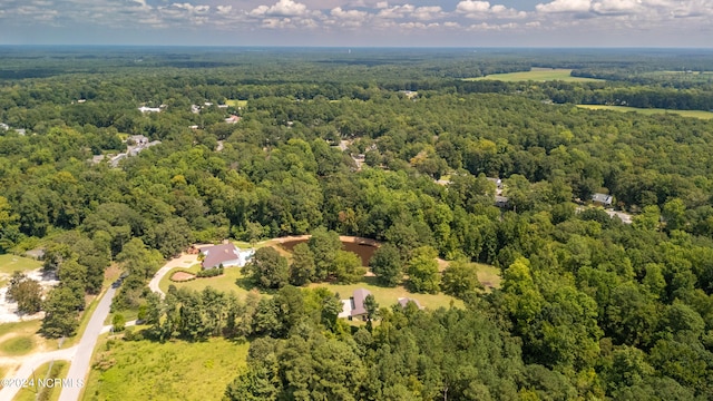 drone / aerial view with a wooded view