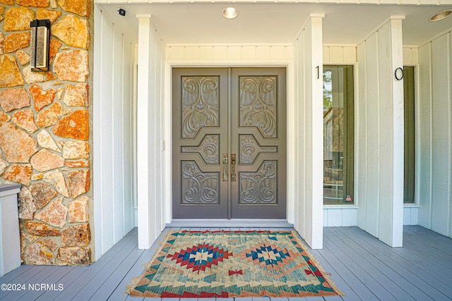 property entrance featuring board and batten siding