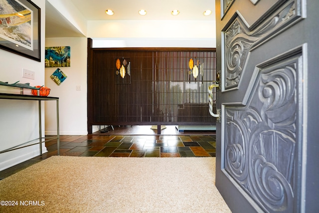 carpeted foyer with baseboards and recessed lighting