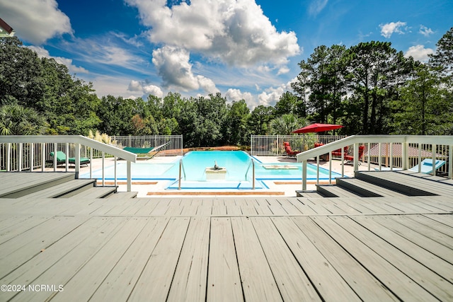 view of pool featuring fence, a fenced in pool, and a wooden deck