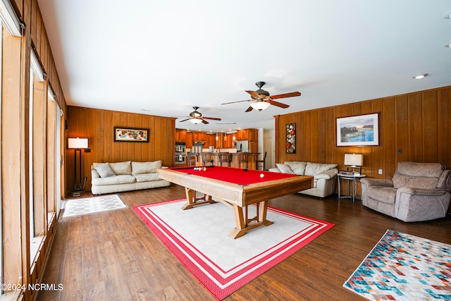 recreation room with dark hardwood / wood-style flooring, ceiling fan, wooden walls, and pool table