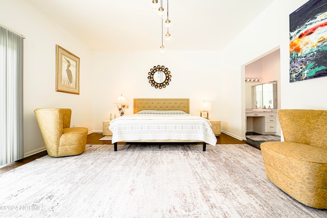 bedroom with baseboards and wood finished floors