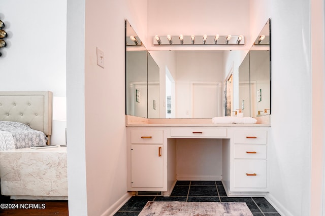 bathroom with tile patterned floors, baseboards, connected bathroom, and vanity