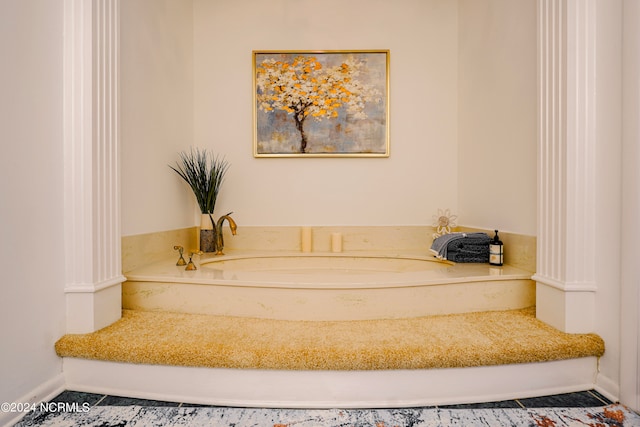 full bathroom featuring a garden tub and baseboards