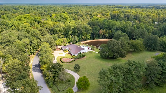 birds eye view of property with a view of trees