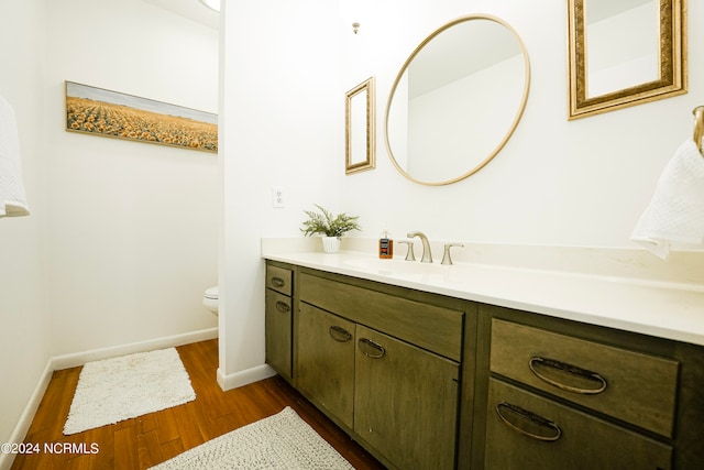 bathroom featuring hardwood / wood-style floors, vanity, and toilet