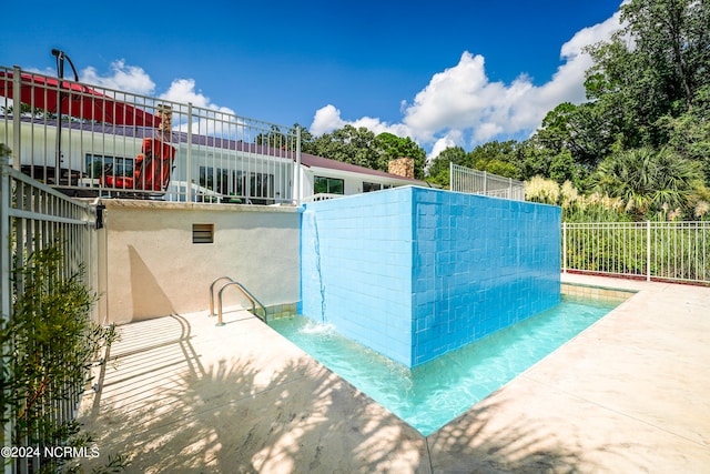 view of swimming pool featuring a patio area