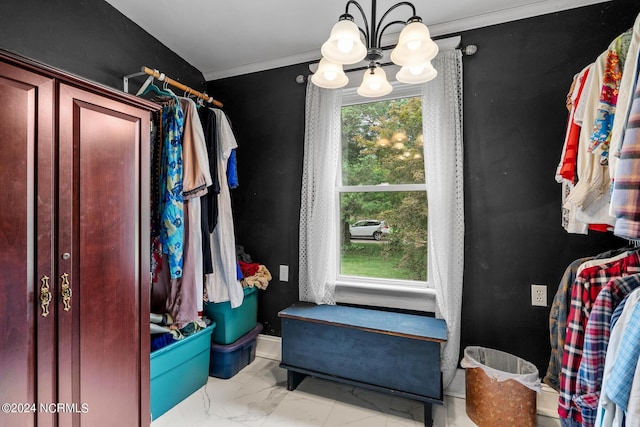 walk in closet featuring marble finish floor and a notable chandelier