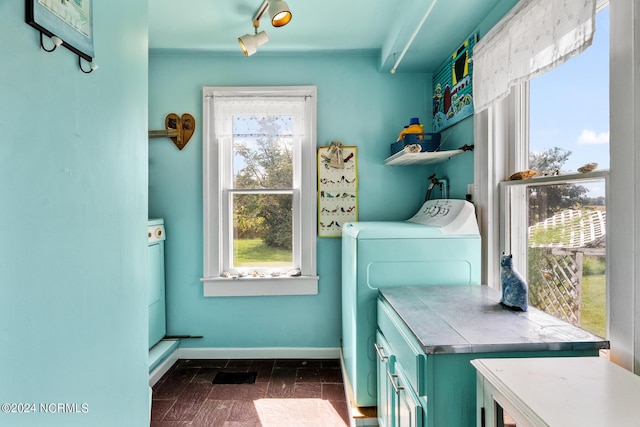 laundry area with cabinet space, washer and clothes dryer, and baseboards