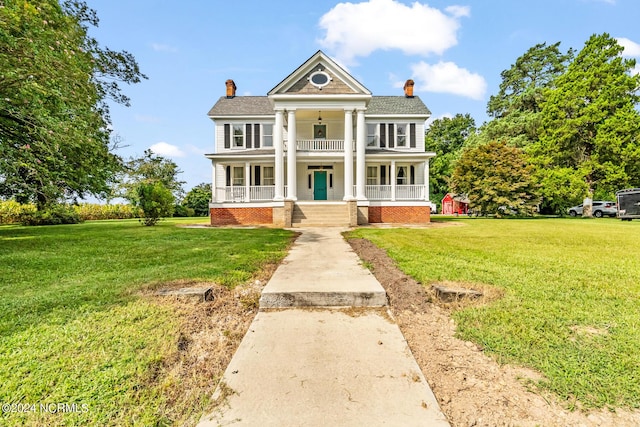 greek revival house featuring a porch, a chimney, and a front lawn