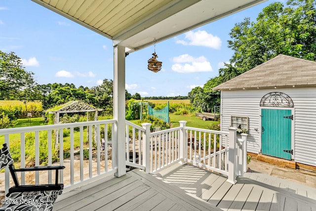 wooden deck with an outbuilding and a yard