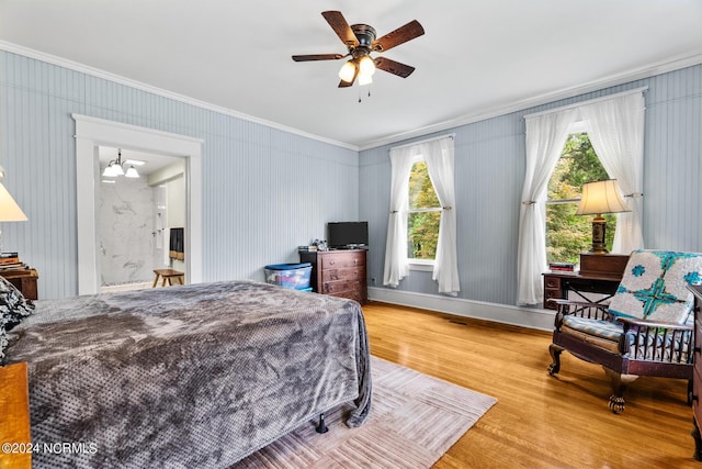 bedroom with ornamental molding, a chandelier, and wood finished floors