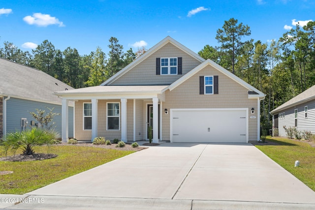 view of front of home with a front yard and a garage