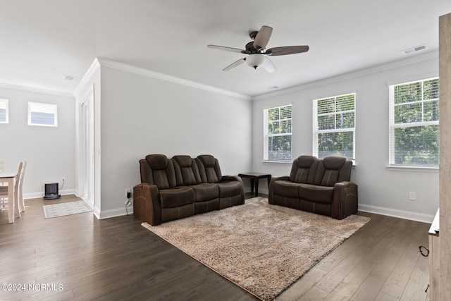 living room with crown molding, dark wood-type flooring, a healthy amount of sunlight, and ceiling fan