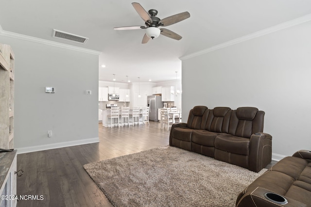 living room with crown molding, dark wood-type flooring, and ceiling fan