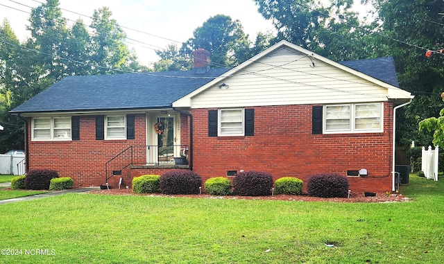 view of front of property with brick siding, roof with shingles, crawl space, a front lawn, and a chimney