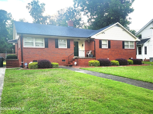 view of front facade with a front lawn and central AC unit