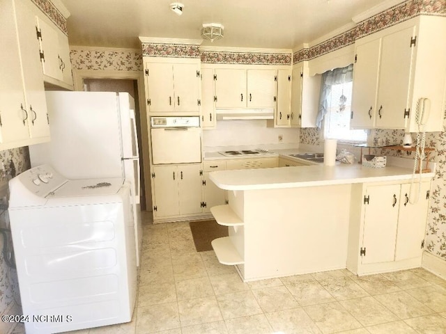 kitchen with washer / clothes dryer, light countertops, white appliances, a peninsula, and under cabinet range hood