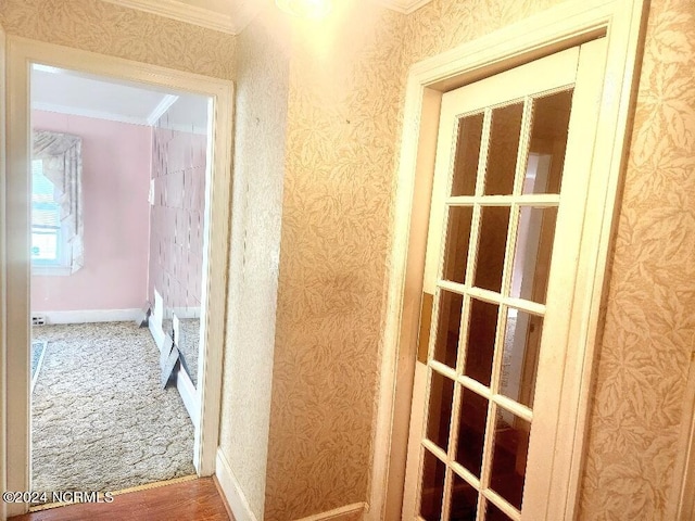 hall featuring baseboards, ornamental molding, and wallpapered walls