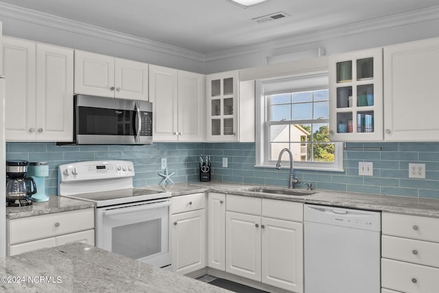 kitchen featuring white appliances, visible vents, white cabinets, ornamental molding, and a sink