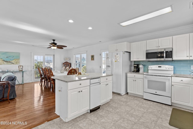 kitchen featuring white appliances, white cabinetry, and ornamental molding