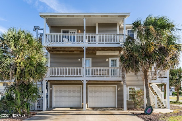 raised beach house with a garage and covered porch