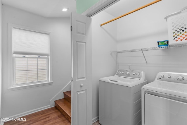 washroom featuring laundry area, baseboards, wood finished floors, separate washer and dryer, and recessed lighting