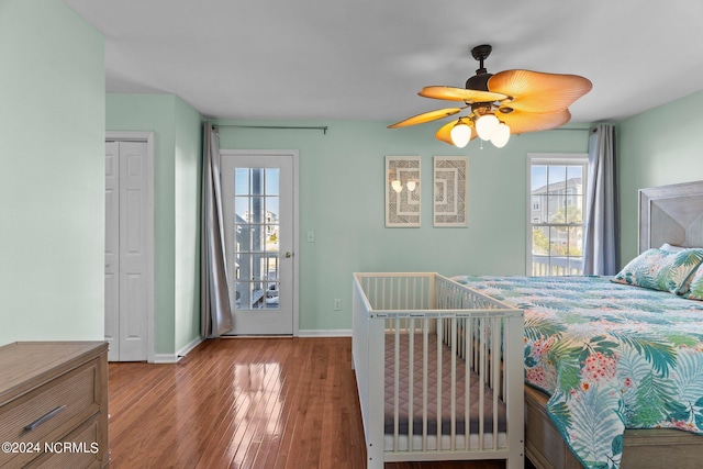 bedroom featuring wood finished floors, a ceiling fan, and baseboards