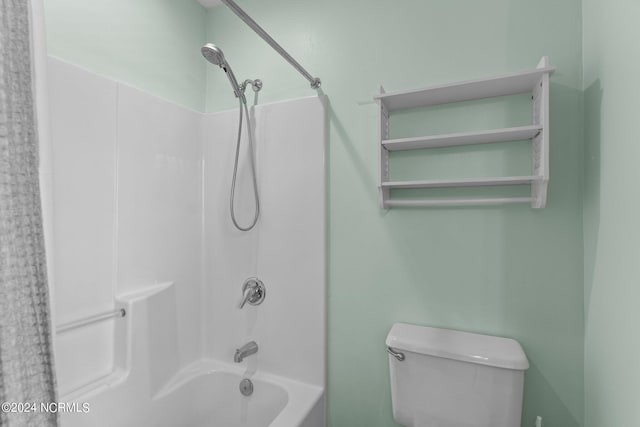 bathroom featuring bathtub / shower combination and toilet