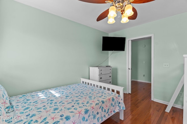 bedroom featuring ceiling fan, wood finished floors, and baseboards