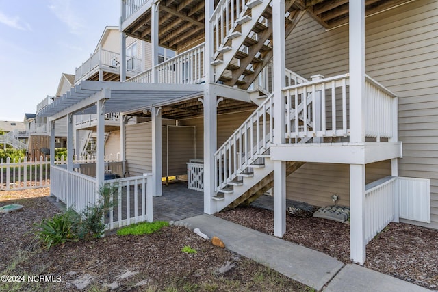 view of side of property with stairs and fence