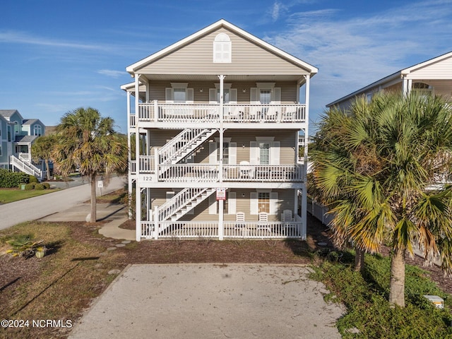 raised beach house with covered porch and stairs