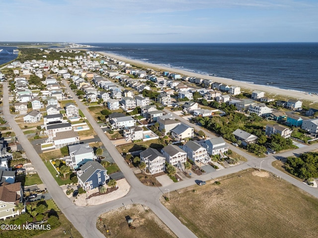 aerial view with a beach view, a water view, and a residential view