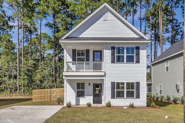 view of front of property with a balcony and a front yard