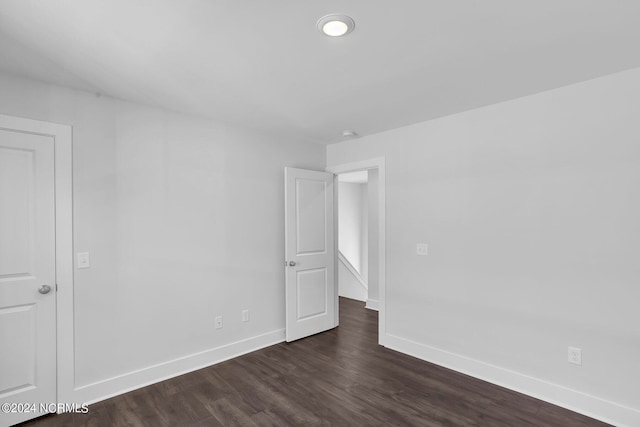 unfurnished room featuring dark hardwood / wood-style flooring