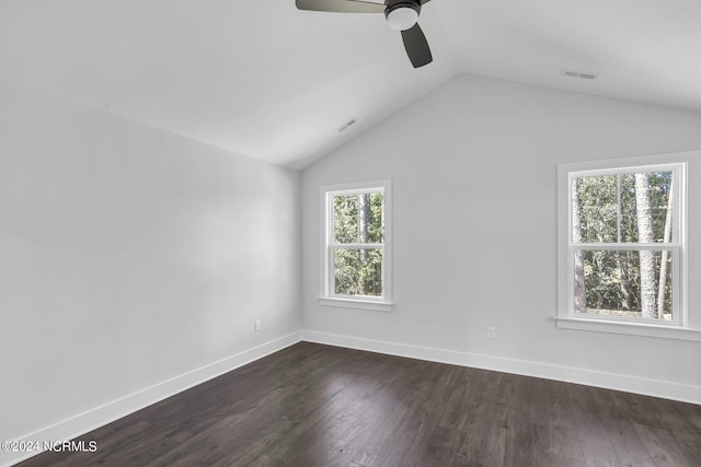 unfurnished room with ceiling fan, a wealth of natural light, and dark hardwood / wood-style flooring