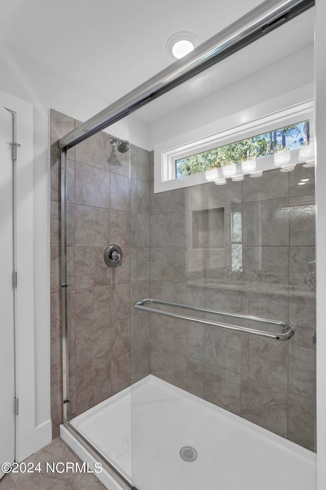 bathroom with a shower with shower door