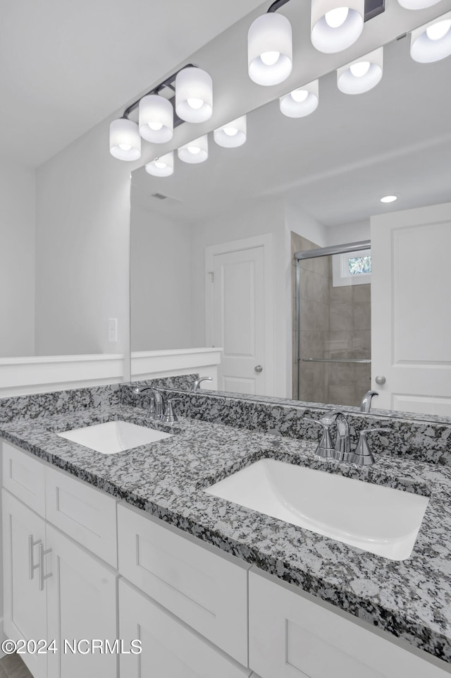 bathroom featuring vanity and an enclosed shower