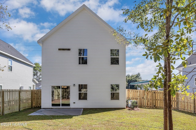 back of property featuring cooling unit, a lawn, and a patio