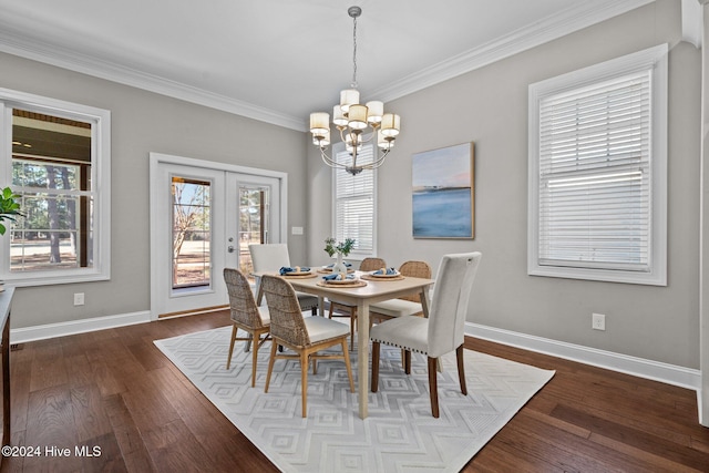 dining room featuring baseboards, dark wood-style flooring, an inviting chandelier, crown molding, and french doors