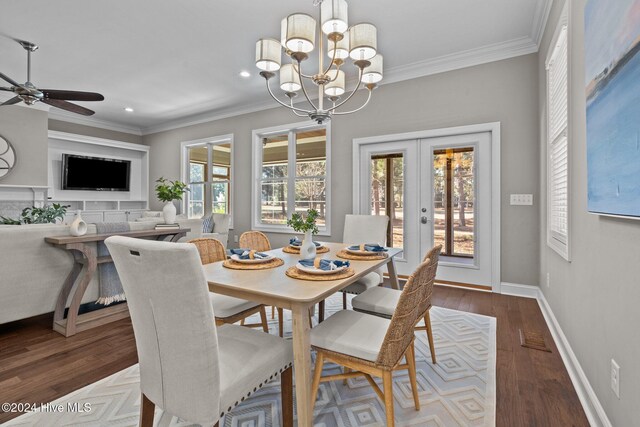 dining space with wood finished floors, visible vents, baseboards, french doors, and crown molding