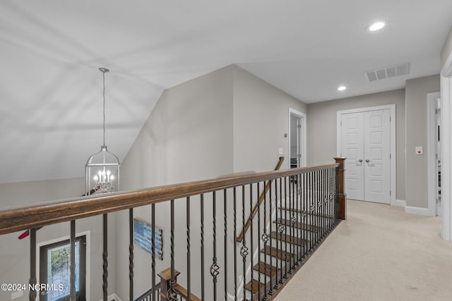 hall featuring visible vents, carpet, an upstairs landing, a chandelier, and recessed lighting