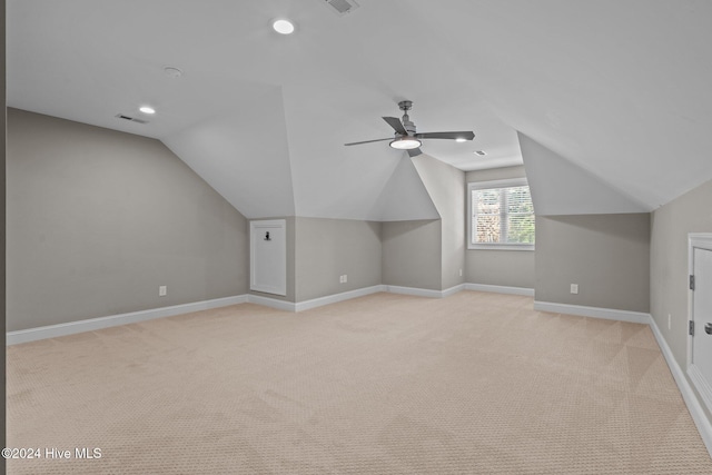 additional living space featuring lofted ceiling, recessed lighting, light colored carpet, visible vents, and baseboards