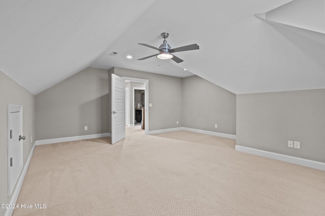 bonus room featuring light carpet, visible vents, baseboards, ceiling fan, and vaulted ceiling