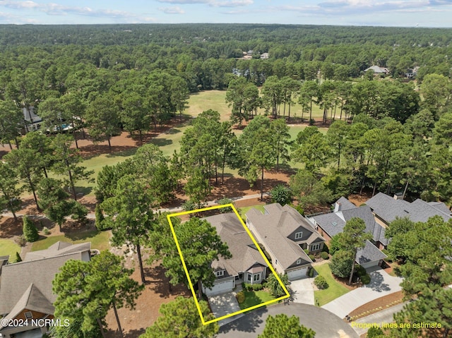 birds eye view of property featuring a forest view and a residential view