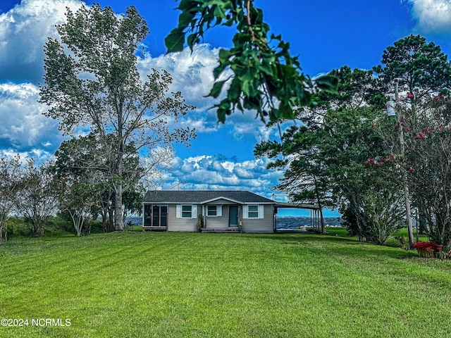 view of front facade with a carport and a front lawn