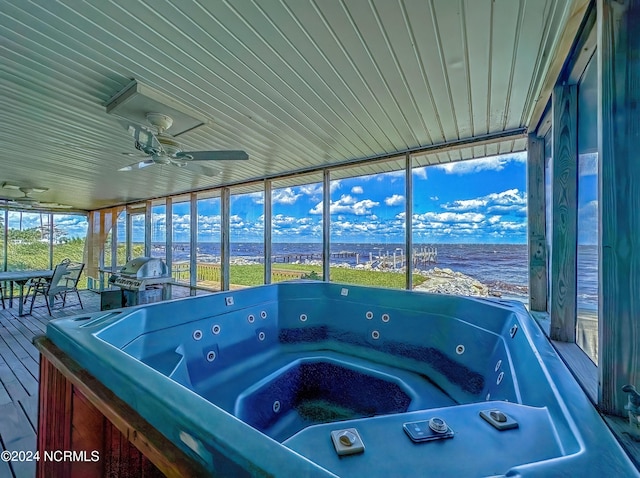 unfurnished sunroom with wooden ceiling, a jacuzzi, and ceiling fan